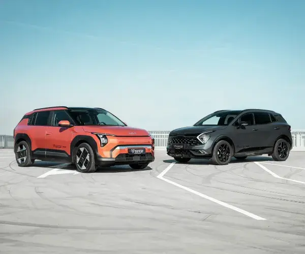 Een Kia EV3 en een Kia Sportage op een parkeerterrein