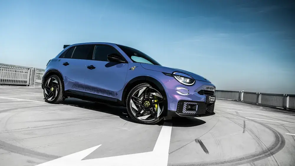 Een nieuwe Abarth 600e in Hypnotic Purple staat geparkeerd op een parkeerplaats.